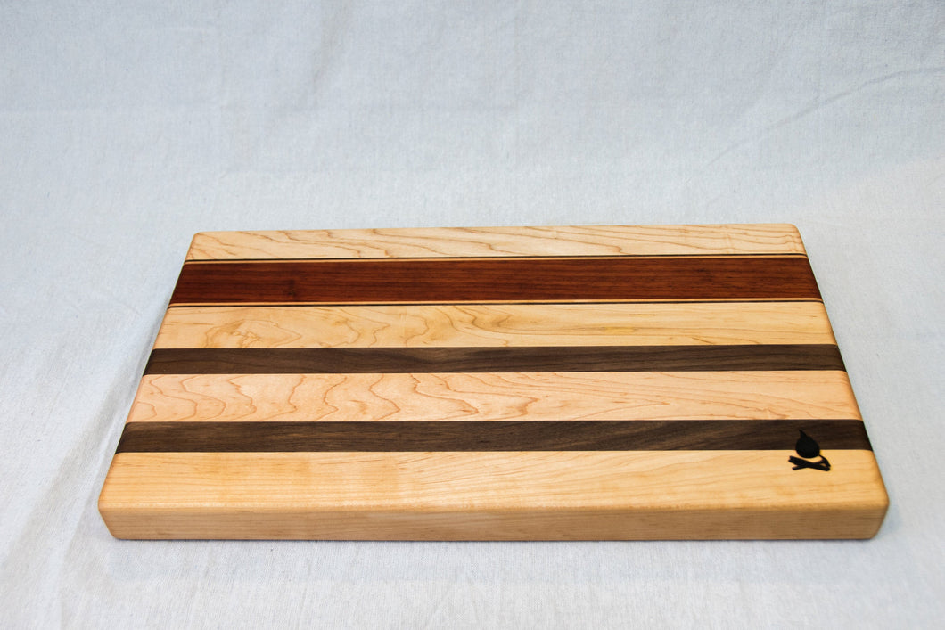 Maple with stripes of Walnut and Padauk Cutting Board